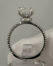 Load image into Gallery viewer, Radiant diamond ring seen through the band, showing the round diamonds