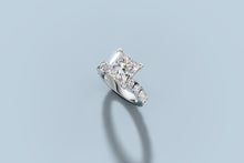 Load image into Gallery viewer, Princess-cut lab diamond ring lying at an angle, showing the high four-prong head and shared-prong diamond shank in 14k white gold