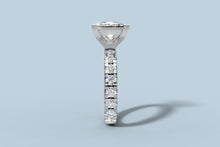 Load image into Gallery viewer, End-on view of princess diamond ring looking down the shared-prong band of round brilliants toward the V-prong head