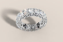 Load image into Gallery viewer, Angled top view of full-circle oval diamond eternity band in 14k white gold, ovals set end to end with the cut-out gallery visible inside