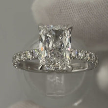 Load image into Gallery viewer, Radiant diamond ring with pave band on a ring stand