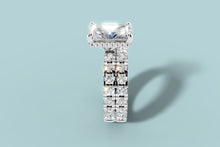 Load image into Gallery viewer, Side profile of radiant diamond ring revealing the hidden halo of round brilliants beneath the basket and the two pave bands