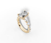 Load image into Gallery viewer, Angled close view of the radiant-cut center showing the pave hidden halo and alternating marquise and round diamonds on the shank