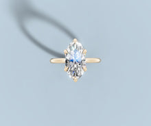 Load image into Gallery viewer, Top view of a marquise-cut lab diamond solitaire in 14k yellow gold