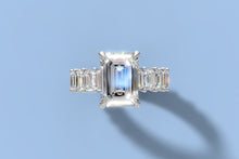 Load image into Gallery viewer, Top view of emerald-cut lab diamond ring showing four claw prongs and the shared-prong eternity shank of emerald-cut diamonds in 14k white gold