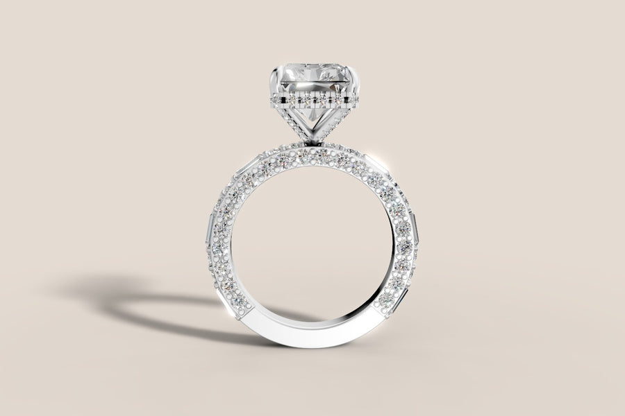 Front profile of radiant lab diamond hidden halo engagement ring in 14k white gold, showing the pavé basket and the three-sided band of round brilliants with baguette stations