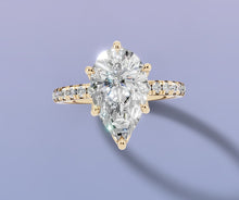 Load image into Gallery viewer, Top view of pear lab diamond ring showing the six-prong setting and pave band in 14k yellow gold