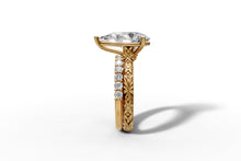 Load image into Gallery viewer, Through-the-finger view of hand-carved leaf and blossom band under the pear diamond, 14k yellow gold
