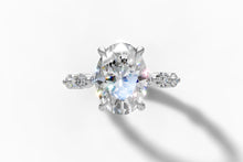 Load image into Gallery viewer, Top view of oval center diamond with marquise and round accent diamonds down the band