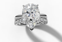 Load image into Gallery viewer, Top view of pear-cut lab diamond with chevron tip prong over a pave band in 14k white gold