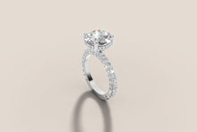 Load image into Gallery viewer, Angled view of the round diamond hidden halo engagement ring with pave set band in 14k gold