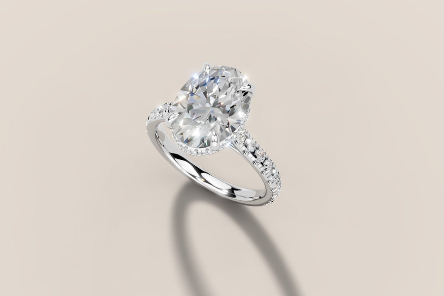 Oval diamond hidden halo engagement ring with pavé band in 14k gold, view 4