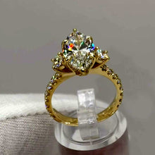 Load image into Gallery viewer, Marquise diamond ring with pavé band, front view on the stand
