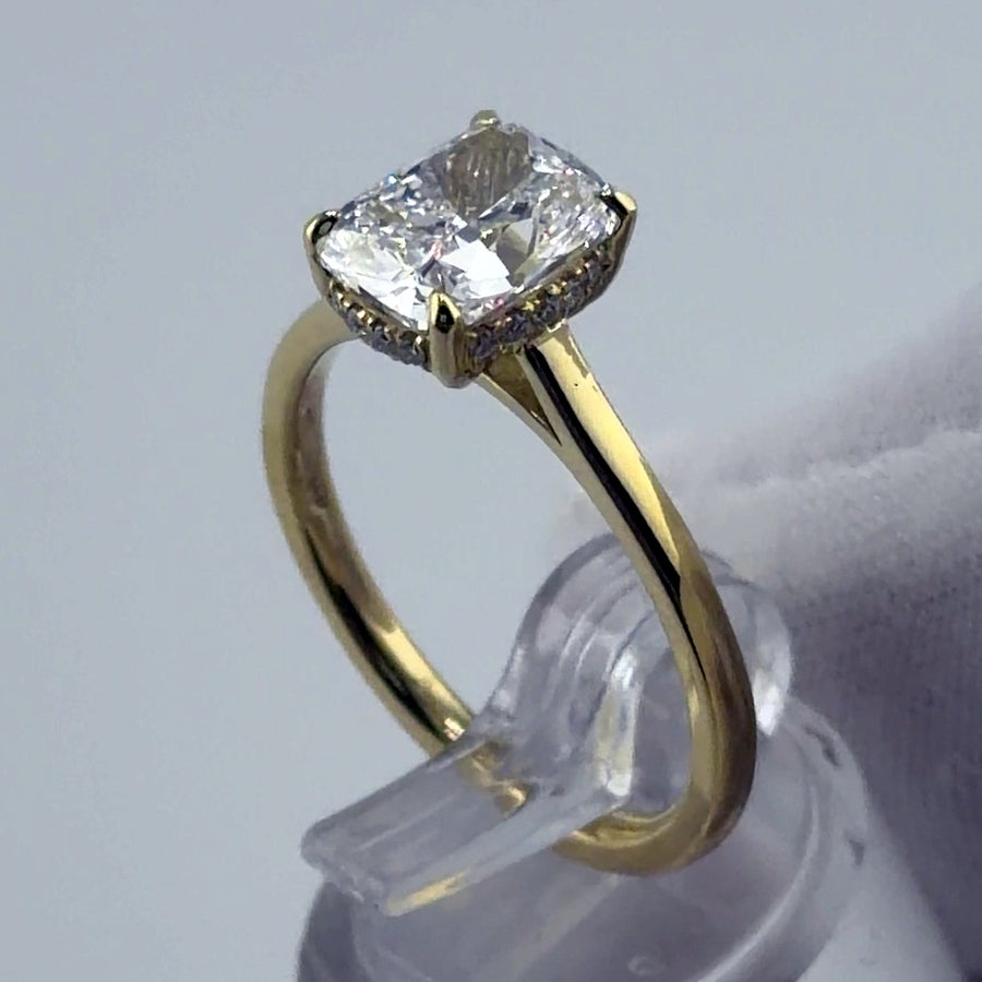 Cushion lab diamond solitaire with hidden halo in yellow gold, three-quarter view