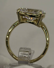 Load image into Gallery viewer, Oval bypass ring seen through the band, four-prong basket
