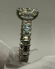 Load image into Gallery viewer, Side profile showing the hidden halo and emerald-cut diamonds down the band
