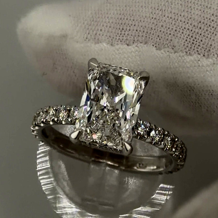 Radiant lab diamond ring with hidden halo and diamond band in 14k white gold, three-quarter view