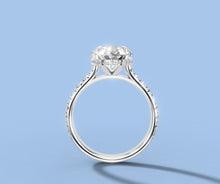 Load image into Gallery viewer, Side profile of oval diamond ring revealing the hidden halo of round brilliants beneath the basket
