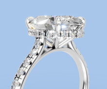 Load image into Gallery viewer, Close-up of the hidden halo and claw prongs under the oval center, pave shank running down the shoulder

