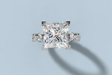 Load image into Gallery viewer, Top view of princess-cut lab diamond ring showing the square center held by four corner prongs and round brilliants along the band in 14k white gold
