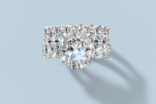 Load image into Gallery viewer, Top view of the oval diamond ring set with eight oval accents on the engagement ring and eight on the matching band in 14k white gold
