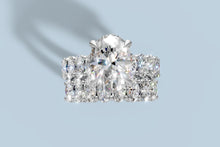 Load image into Gallery viewer, Top view of the oval lab diamond ring set with the four-claw center above the full row of ovals on the matching band in 14k white gold

