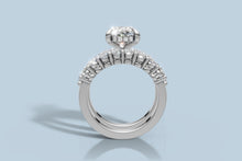 Load image into Gallery viewer, Straight-on profile of the oval diamond engagement ring and band showing the hidden halo and shared-prong oval accents in 14k white gold
