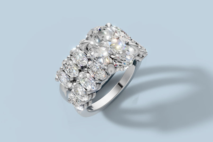 Oval lab diamond bridal set with hidden halo and oval-accent shank stacked with its matching oval band in 14k white gold, three-quarter view