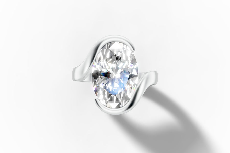 Oval lab diamond engagement ring in a full bezel with a sweeping bypass shank in 14k white gold, top view