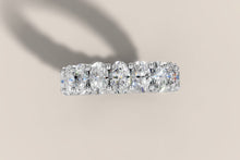 Load image into Gallery viewer, Top view of oval lab diamond eternity band in 14k white gold showing the elongated ovals and small beaded prongs between each stone
