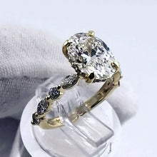 Load image into Gallery viewer, Oval diamond ring with marquise and round diamonds spaced along the band
