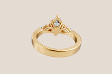 Load image into Gallery viewer, Back view of marquise diamond ring showing twisted split shoulders in 14k yellow gold
