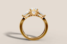 Load image into Gallery viewer, Front view of marquise and pear diamond three-stone ring in 14k yellow gold
