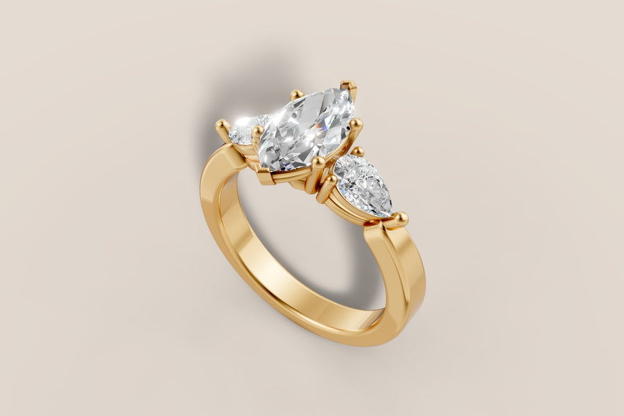 Marquise diamond engagement ring with pear side stones and twisted shoulders in 14k yellow gold, hand-made by Asik Jewelry Los Angeles
