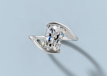 Load image into Gallery viewer, Top view of radiant lab diamond bypass ring showing the two curved gold bars that hold each end of the stone in 14k white gold
