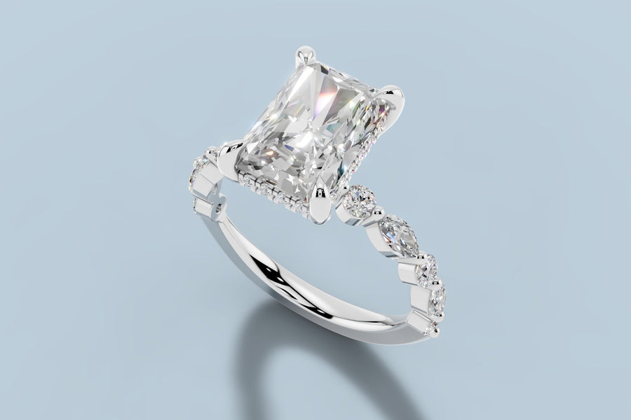 Radiant lab diamond engagement ring with hidden halo and alternating round and marquise shared-prong shank in 14k white gold, three-quarter view