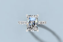Load image into Gallery viewer, Top view of radiant lab diamond ring showing four claw prongs and the round and marquise accent stones along the band in 14k white gold
