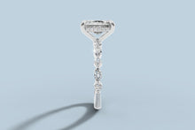 Load image into Gallery viewer, Side profile of radiant diamond ring revealing the hidden halo of round brilliants beneath the basket and the marquise and round stones down the shank
