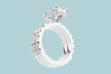 Load image into Gallery viewer, Tilted underside view of radiant diamond ring showing the open basket, hidden halo and double band in 14k white gold
