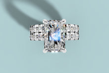 Load image into Gallery viewer, Overhead view of radiant lab diamond double-band ring with four prongs and rows of round diamonds
