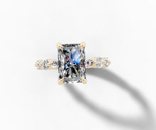 Load image into Gallery viewer, Top view of the radiant-cut diamond with east-west marquise and round diamonds along the band

