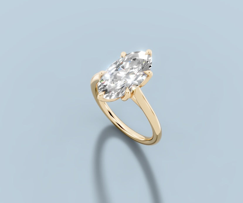 Marquise-cut lab diamond solitaire in 14k yellow gold, three-quarter view showing the claw prongs and polished band