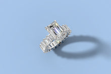 Load image into Gallery viewer, Angled top view of emerald-cut lab diamond ring with emerald-cut eternity shank in 14k white gold
