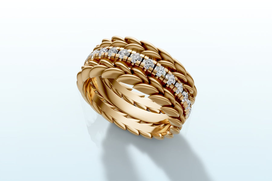 Three-piece stacking ring set in 14k yellow gold with a row of round lab diamonds framed by two wheat braid bands, three-quarter view