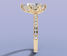 Load image into Gallery viewer, Side profile of pear diamond ring showing the hidden halo of round brilliants beneath the basket and the pave running down the shank

