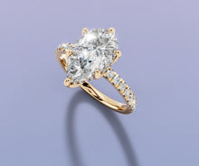 Load image into Gallery viewer, Tilted top view of pear lab diamond engagement ring with claw prongs and pave band in 14k yellow gold
