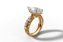 Load image into Gallery viewer, Full view of pear diamond engagement ring standing upright, carved floral 14k yellow gold band with pave diamonds
