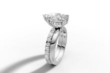 Load image into Gallery viewer, Standing angled view of pear diamond hidden halo ring with double band in 14k white gold
