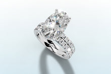 Load image into Gallery viewer, Angled close-up of oval lab diamond with hidden halo and twin pave rows in 14k white gold
