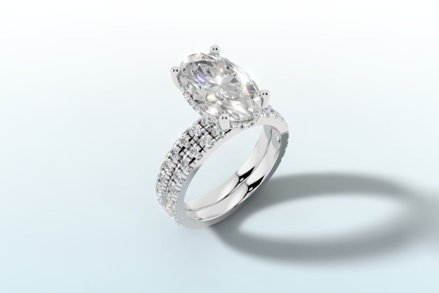 Oval lab diamond engagement ring with hidden halo and double-row french pave shank in 14k white gold, three-quarter view